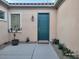 Charming front entrance featuring a blue door, small garden, and a welcome mat at 2764 Leys Burnett Ave, Henderson, NV 89044