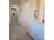 Neutral toned hallway showcasing an arched display and entry to another room at 2764 Leys Burnett Ave, Henderson, NV 89044