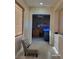 Hallway showcasing neutral tones, tile flooring, and an open doorway to another room at 2764 Leys Burnett Ave, Henderson, NV 89044