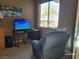 View of an office space featuring a computer desk, chair and picture window overlooking the yard at 2764 Leys Burnett Ave, Henderson, NV 89044