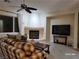 Inviting living room with a fireplace, ceiling fan and comfortable furniture at 2764 Leys Burnett Ave, Henderson, NV 89044