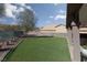 Backyard showcasing artificial turf, gravel, mature trees, and a partial view of the house at 2987 Matese Dr, Henderson, NV 89052