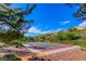 Outdoor basketball court surrounded by trees and landscaping, perfect for recreational activities at 2987 Matese Dr, Henderson, NV 89052