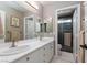 Bathroom showcasing a double vanity with white countertops and cabinetry, as well as a shower at 2987 Matese Dr, Henderson, NV 89052