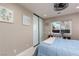 Bedroom features a large closet, ceiling fan, neutral walls, a window, and a blue comforter at 2987 Matese Dr, Henderson, NV 89052