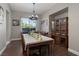 Bright dining room with a large window, elegant chandelier, and hardwood floors at 2987 Matese Dr, Henderson, NV 89052