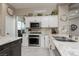 Modern kitchen featuring stainless appliances, granite countertops, and tiled flooring at 2987 Matese Dr, Henderson, NV 89052