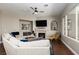 Inviting living room featuring a fireplace, plush sectional, and natural light at 2987 Matese Dr, Henderson, NV 89052