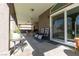 Covered patio featuring tiled floors, outdoor seating, and sliding glass doors for seamless indoor-outdoor living at 2987 Matese Dr, Henderson, NV 89052