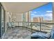 Condo balcony with a tile floor, lounge chair, sitting chairs, and views of the city at 322 Karen Ave # 1101, Las Vegas, NV 89109