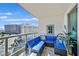 Inviting balcony with stylish blue seating, a glass table, and a decorative mirror with city view at 322 Karen Ave # 1101, Las Vegas, NV 89109