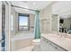 Bright bathroom featuring a tub with shower, a vanity with marble countertop, and a city view at 322 Karen Ave # 1101, Las Vegas, NV 89109