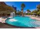 A beautiful pool surrounded by tropical foliage and a rock waterfall feature at 322 Karen Ave # 1101, Las Vegas, NV 89109