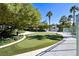 Well-manicured putting green surrounded by lush landscaping and mature trees at 322 Karen Ave # 1101, Las Vegas, NV 89109