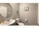 Small bathroom with white vanity, toilet, and circular mirror at 3498 Monte Cervino Ave, Henderson, NV 89044