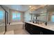 Elegant bathroom with double vanity, soaking tub and shower at 3498 Monte Cervino Ave, Henderson, NV 89044