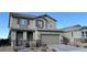 Two-story house with taupe exterior, red shutters, and a three-car garage at 3498 Monte Cervino Ave, Henderson, NV 89044