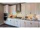 White shaker cabinets, granite countertops and stainless steel appliances in this kitchen at 3498 Monte Cervino Ave, Henderson, NV 89044