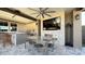 Covered patio with fireplace, outdoor kitchen, and seating area at 3498 Monte Cervino Ave, Henderson, NV 89044