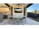 Covered patio with fireplace, outdoor dining, and TV at 3498 Monte Cervino Ave, Henderson, NV 89044