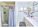 Bathroom featuring a shower stall with a shower curtain and double sink vanity at 3826 S Torrey Pines Dr, Las Vegas, NV 89103