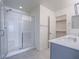 Bathroom featuring a glass-enclosed shower, double vanity sinks, and a walk-in closet at 4550 Kali Lyn St, North Las Vegas, NV 89031