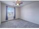 Inviting bedroom with soft carpeting and large window dressed with blue curtains at 4550 Kali Lyn St, North Las Vegas, NV 89031