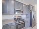 Kitchen features granite countertops, stainless steel appliances, and gray cabinets at 4550 Kali Lyn St, North Las Vegas, NV 89031