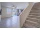 Open-concept layout with tile flooring leading to the kitchen, adjacent to carpeted stairs at 4550 Kali Lyn St, North Las Vegas, NV 89031