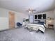 Bright main bedroom featuring neutral tones, ceiling fan, and adjoining bath at 4550 Kali Lyn St, North Las Vegas, NV 89031