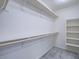 Large walk-in closet with ample shelving and a wooden clothes rod for optimal storage at 4550 Kali Lyn St, North Las Vegas, NV 89031