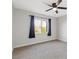 Bright bedroom with window, ceiling fan, and neutral carpeting at 465 Federal St, Henderson, NV 89015