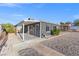 Side view of a gray house with a covered patio and gravel landscaping at 465 Federal St, Henderson, NV 89015