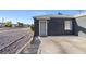 Side view of a gray house with a security door and gravel landscaping at 465 Federal St, Henderson, NV 89015