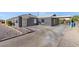 Front view of a gray house with a carport and a gravel driveway at 465 Federal St, Henderson, NV 89015