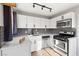 Modern kitchen with white cabinets and gray tile backsplash at 465 Federal St, Henderson, NV 89015