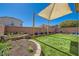 Landscaped backyard with artificial turf, desert plants, and an outdoor seating area at 5329 Fireside Ranch Ave, Las Vegas, NV 89131