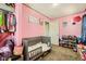 Cozy pink bedroom with a crib, closet, and toy storage at 5329 Fireside Ranch Ave, Las Vegas, NV 89131