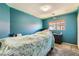 This is a blue bedroom with a bed, dresser, and neutral carpet at 5329 Fireside Ranch Ave, Las Vegas, NV 89131