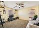 Bedroom featuring a ceiling fan, natural light and a comfortable seating area at 5329 Fireside Ranch Ave, Las Vegas, NV 89131