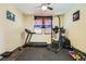 A home exercise room featuring a treadmill, weight rack, and motivational banner at 5329 Fireside Ranch Ave, Las Vegas, NV 89131