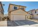 Charming tan two-story home featuring a spacious two-car garage, set against a clear blue sky at 5329 Fireside Ranch Ave, Las Vegas, NV 89131