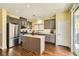 Well-appointed kitchen featuring stainless steel appliances, gray cabinets, and a breakfast bar at 5329 Fireside Ranch Ave, Las Vegas, NV 89131