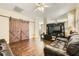 Spacious living room featuring modern barn doors, wood floors, and contemporary decor at 5329 Fireside Ranch Ave, Las Vegas, NV 89131