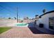 The backyard features a pool, rock ground cover, and a concrete block perimeter fence at 5732 Heron Ave, Las Vegas, NV 89107