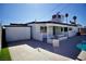 Wide backyard featuring pool, covered patio, palm trees, and a concrete patio area at 5732 Heron Ave, Las Vegas, NV 89107