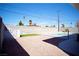 Wide angle view of backyard with a concrete block wall and featuring a pool at 5732 Heron Ave, Las Vegas, NV 89107