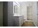 Updated bathroom featuring a stylish vanity, mirror, and a tiled walk-in shower at 5732 Heron Ave, Las Vegas, NV 89107