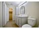 Updated bathroom with a gray vanity, framed mirror, and tiled floor at 5732 Heron Ave, Las Vegas, NV 89107