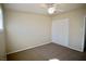 Simple bedroom boasts neutral walls, a ceiling fan, carpeted floor, and a closet at 5732 Heron Ave, Las Vegas, NV 89107